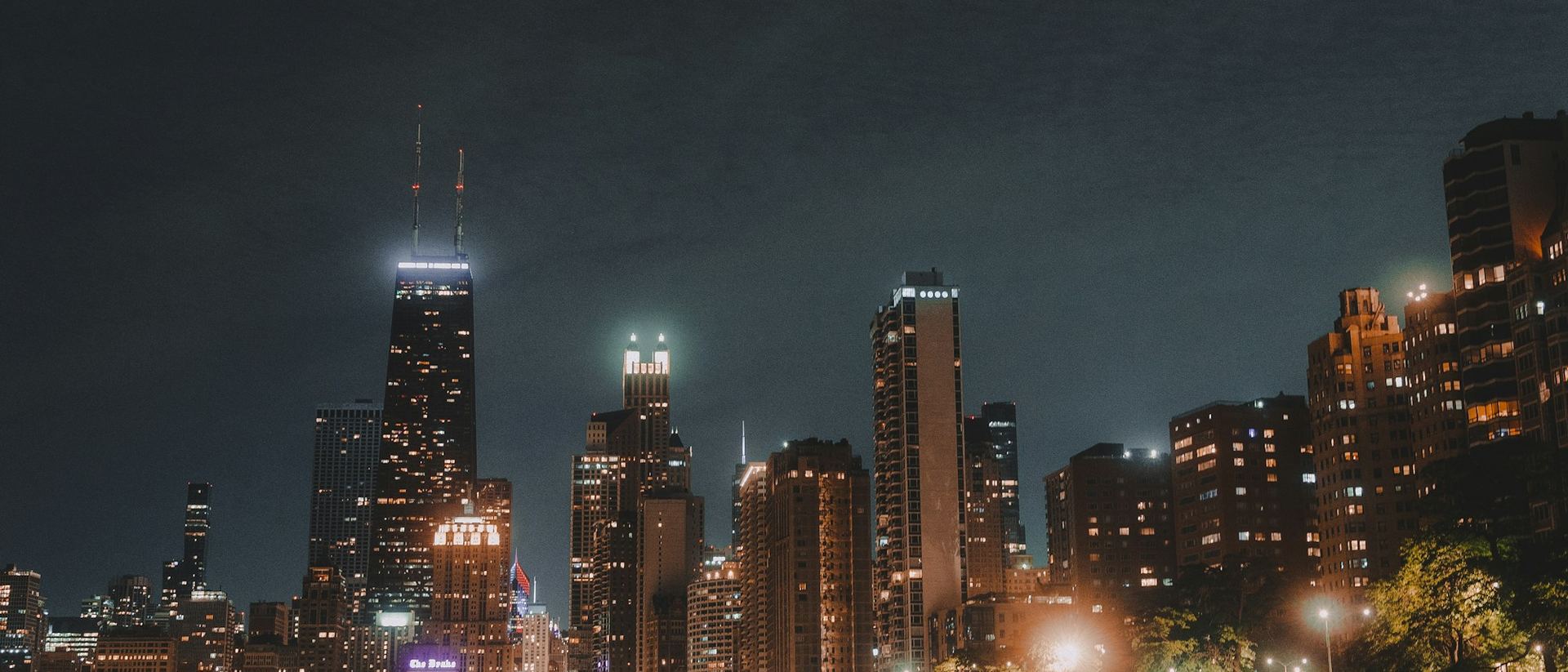 The Chicago skyline at night, reflected in Lake Michigan