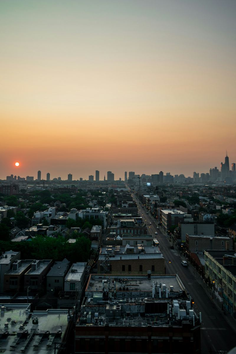 Chicago rooftops at sunset with the skyline on the horizon
